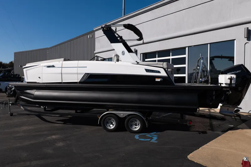 Slide: The Image of 2025 Balise Helix 24C boat on trailer, parked outside a building. - 3