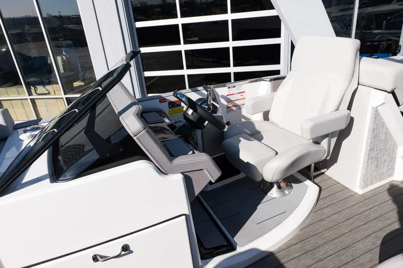 Slide: The Image of Helm of 2025 Balise Helix 24C boat with modern steering and white captain's chair. - 30