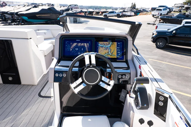 Slide: The Image of 2025 Balise Helix 24C boat dashboard with modern navigation system and steering wheel. - 32