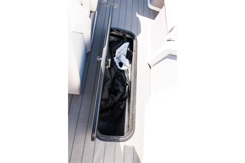 Slide: The Image of Open storage compartment on 2025 Balise Helix 24C boat deck. - 35