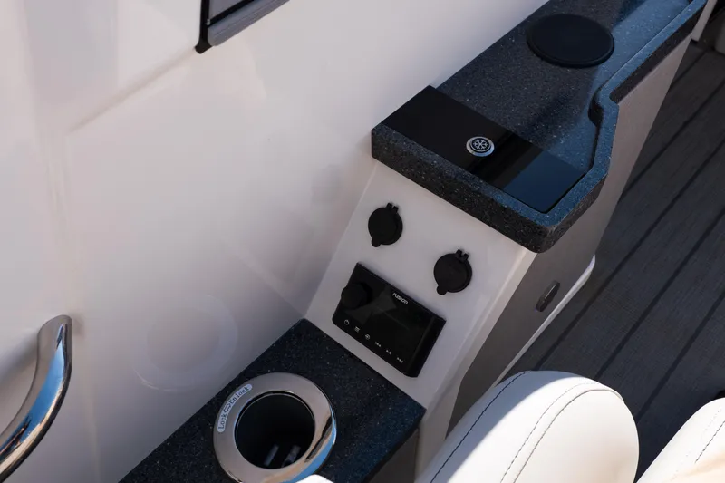 Slide: The Image of Control panel of 2025 Balise Helix 24C boat with cup holder and audio system. - 38