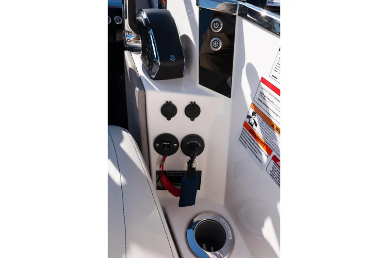 Slide: The Image of Control panel of Balise Helix 24C boat, 2025 model, featuring switches and warning labels. - 41