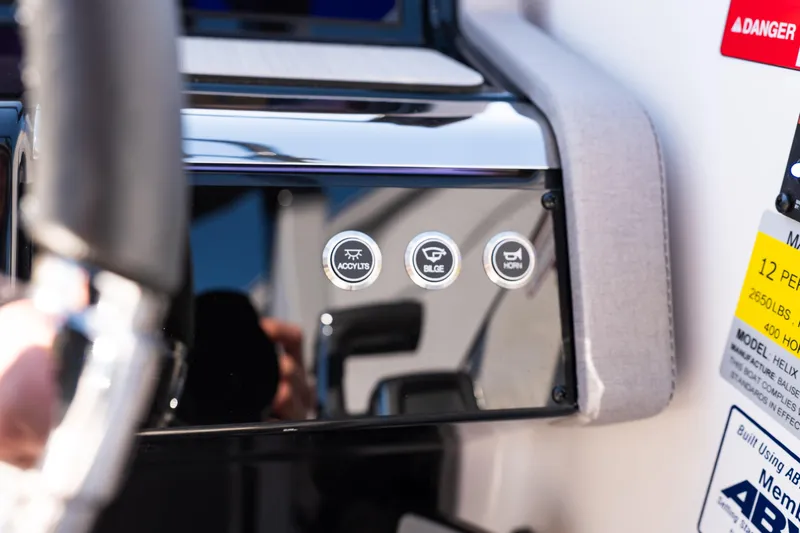 Slide: The Image of Control panel of 2025 Balise Helix 24C boat with buttons for accessories, bilge, and horn. - 43