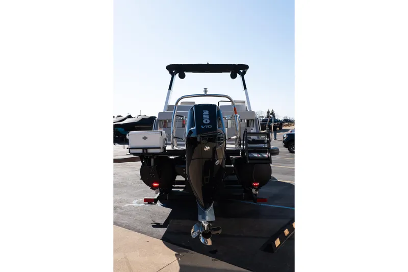 Slide: The Image of 2025 Balise Helix 24C boat with powerful outboard motor, parked outdoors. - 6