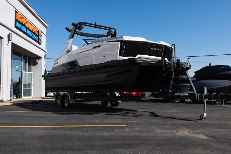 Slide: The Image of 2025 Balise Helix 24C boat on trailer outside marine dealership. - 8