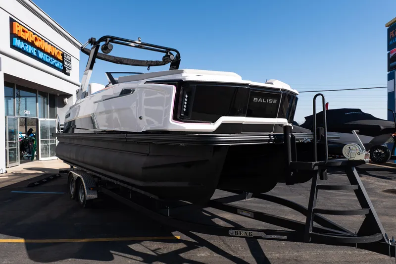 Slide: The Image of 2025 Balise Helix 24C boat on trailer at Performance Marine Watersports dealership. - 9
