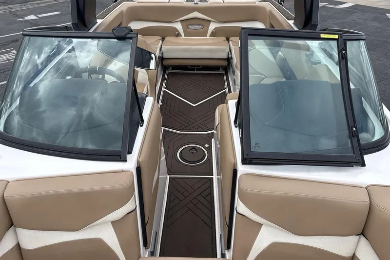 Slide: The Image of Interior view of 2018 Supra SA 550 boat with beige seating and sleek design. - 12