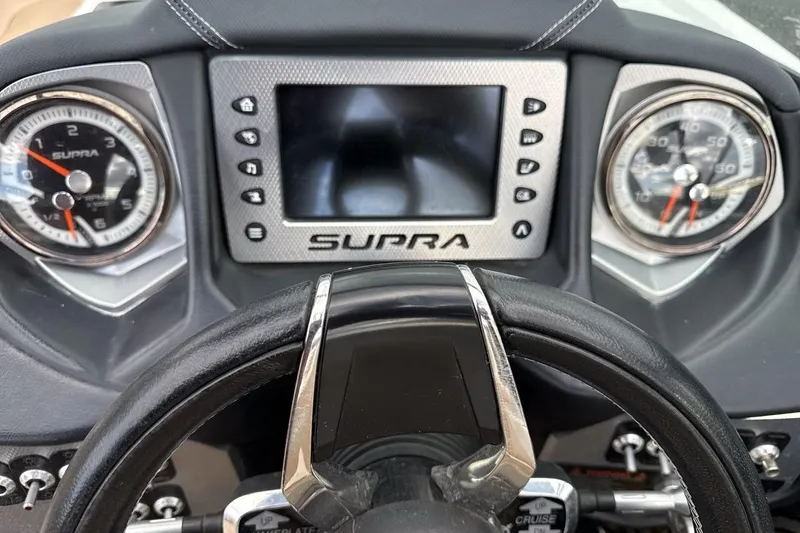 Slide: The Image of Dashboard of a 2018 Supra SA 550 boat with gauges and steering wheel. - 15