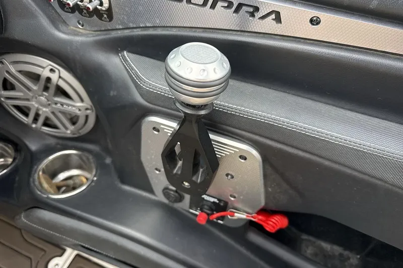 Slide: The Image of Interior of 2018 Supra SA 550 boat with gear shift and speaker detail. - 16