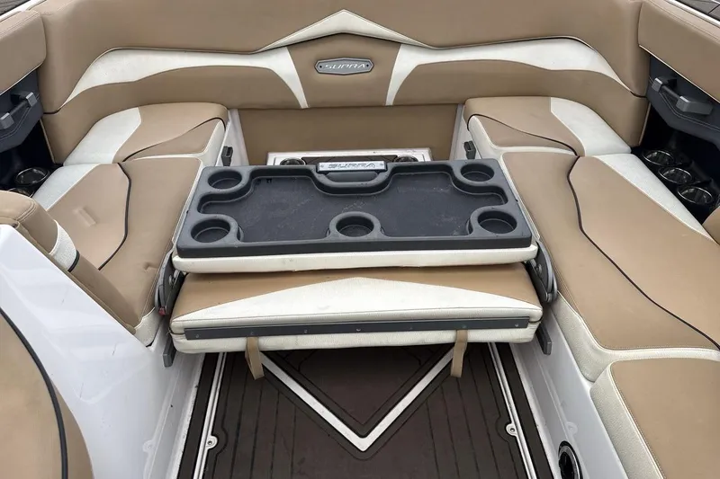 Slide: The Image of 2018 Supra SA 550 boat interior with beige seating and cup holders. - 23