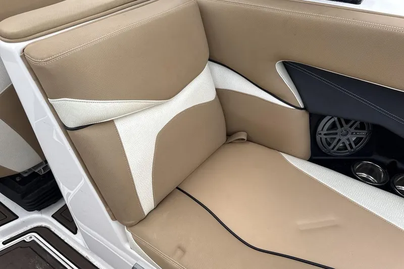 Slide: The Image of 2018 Supra SA 550 boat interior with beige and white seating, JL Audio speaker. - 24