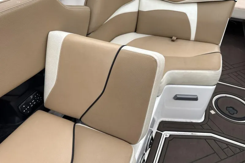 Slide: The Image of 2018 Supra SA 550 boat interior with tan and white seating, modern design. - 25