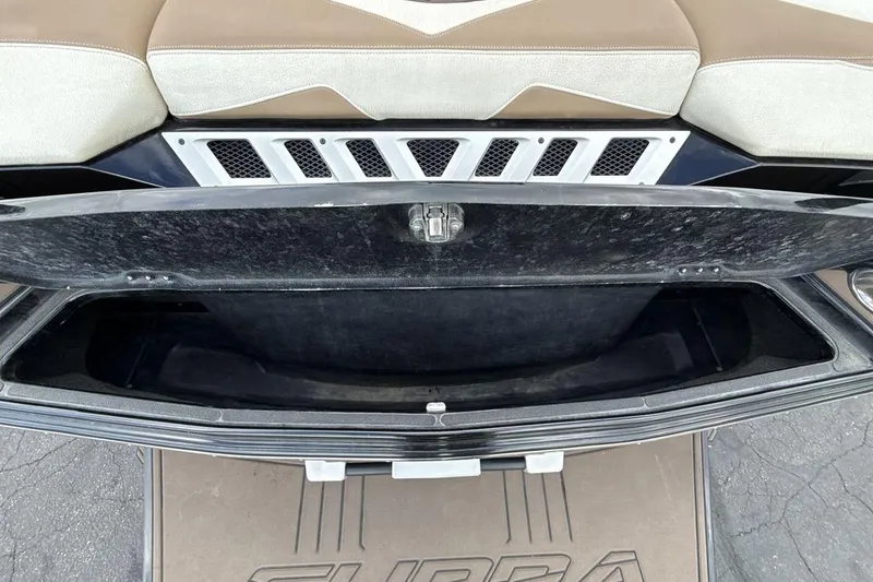 Slide: The Image of Open storage compartment in a 2018 Supra SA 550 boat with cushioned seating. - 26