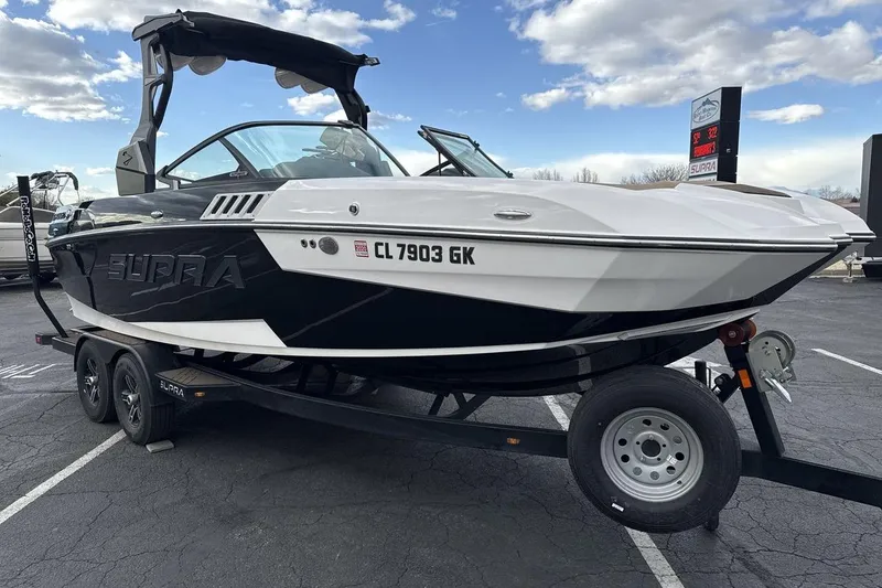 Slide: The Image of 2018 Supra SA 550 boat on trailer, black and white design, parked outdoors. - 7