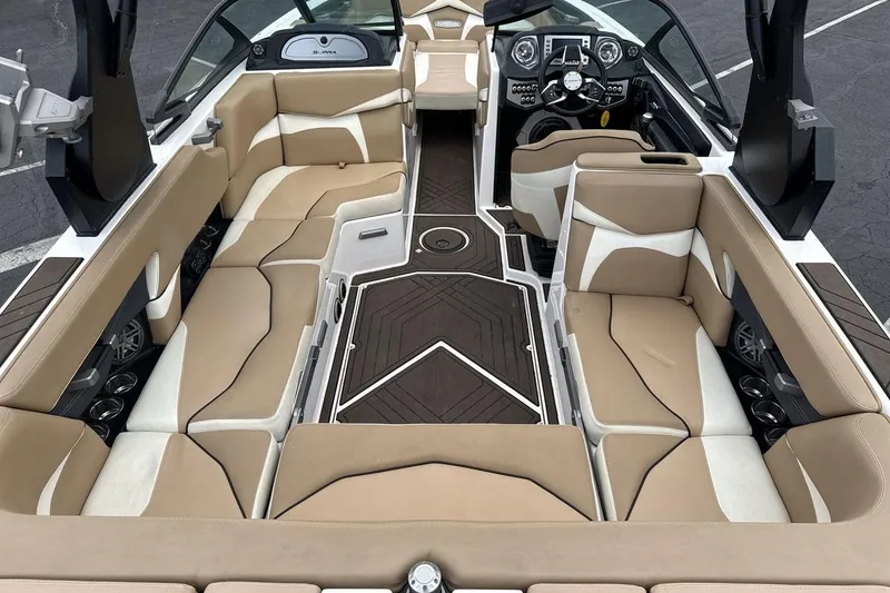 Slide: The Image of 2018 Supra SA 550 boat interior with beige and white seating, modern dashboard, and sleek design. - 9