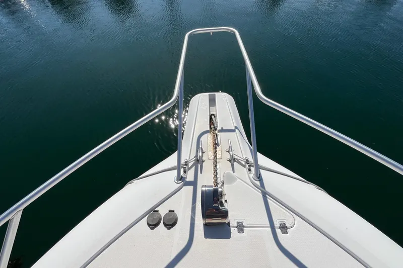 Slide: The Image of Bow view of 1998 Phoenix 32 Tournament boat on calm water. - 14