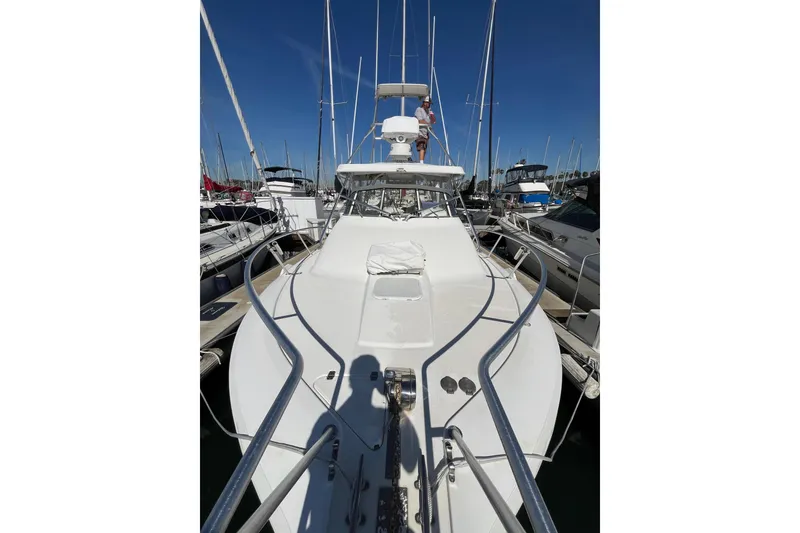 Slide: The Image of 1998 Phoenix 32 Tournament boat docked in a marina, viewed from the bow. - 15