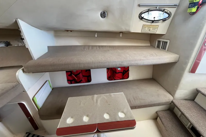 Slide: The Image of Interior of 1998 Phoenix 32 Tournament boat with beige seating and compact table. - 18