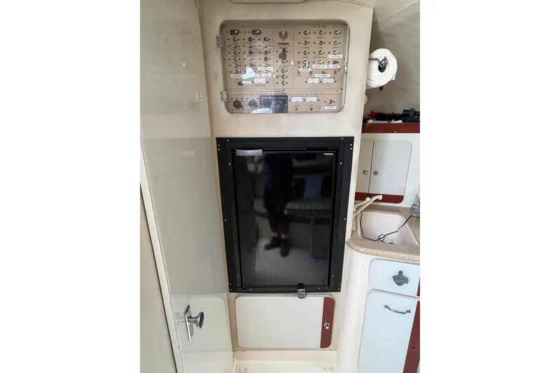 Slide: The Image of Interior of 1998 Phoenix 32 Tournament boat with control panel and kitchenette. - 20