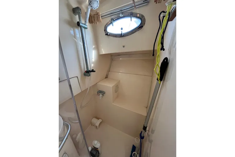 Slide: The Image of Bathroom interior of 1998 Phoenix 32 Tournament boat with shower and porthole. - 22