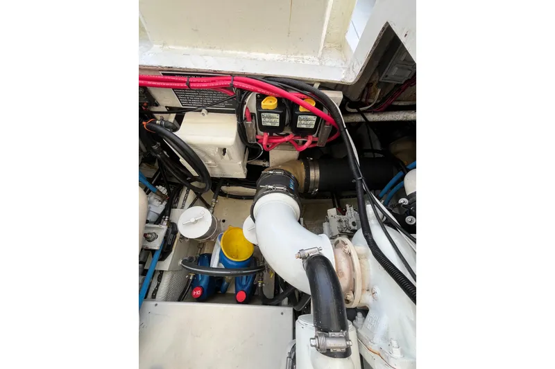 Slide: The Image of Engine compartment of a 1998 Phoenix 32 Tournament boat, showcasing wiring and components. - 25