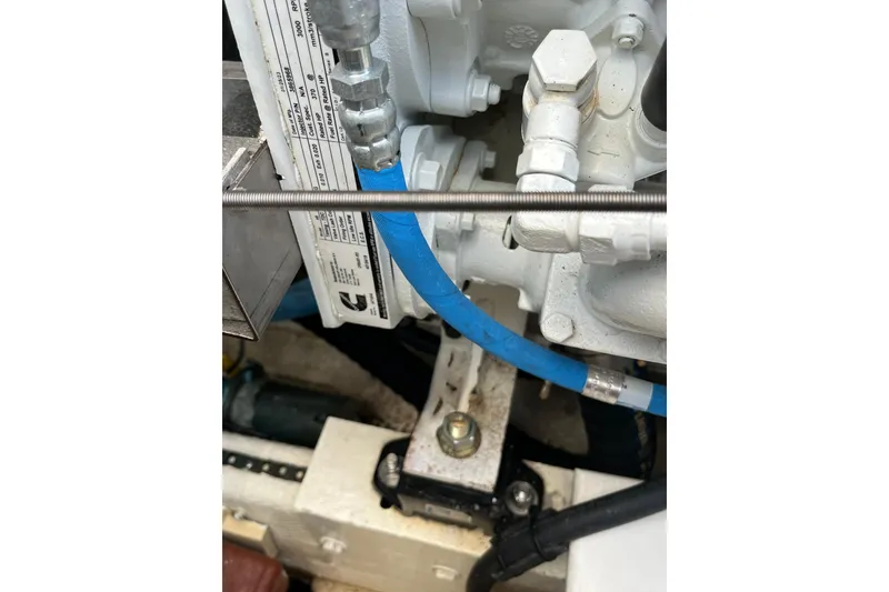 Slide: The Image of Engine components of a 1998 Phoenix 32 Tournament boat, featuring hoses and fittings. - 26