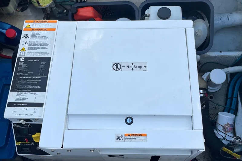 Slide: The Image of Engine compartment of a 1998 Phoenix 32 Tournament boat with warning labels visible. - 28