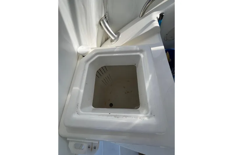 Slide: The Image of White sink on a 1998 Phoenix 32 Tournament boat, featuring a modern faucet. - 9