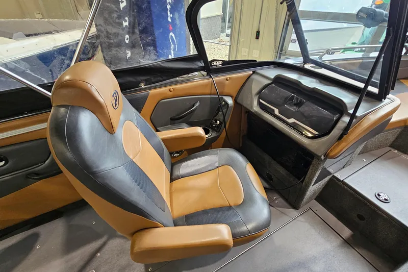 Slide: The Image of 2019 Princecraft Platinum SE 227 boat interior with tan and black captain's chair. - 14