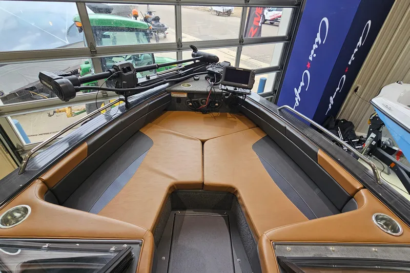 Slide: The Image of 2019 Princecraft Platinum SE 227 boat interior with tan seating and navigation equipment. - 16