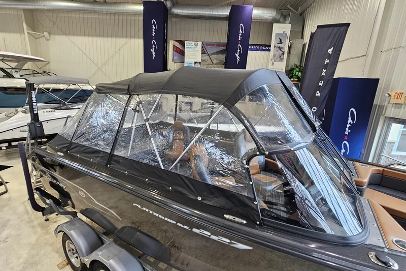 Slide: The Image of 2019 Princecraft Platinum SE 227 boat with canopy in showroom display. - 2