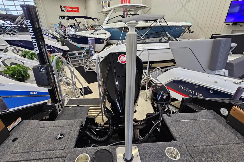 Slide: The Image of 2019 Princecraft Platinum SE 227 boat in showroom, surrounded by other boats. - 21