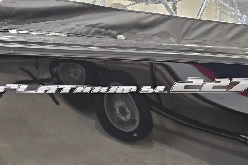 Slide: The Image of 2019 Princecraft Platinum SE 227 boat with sleek black exterior and logo. - 22