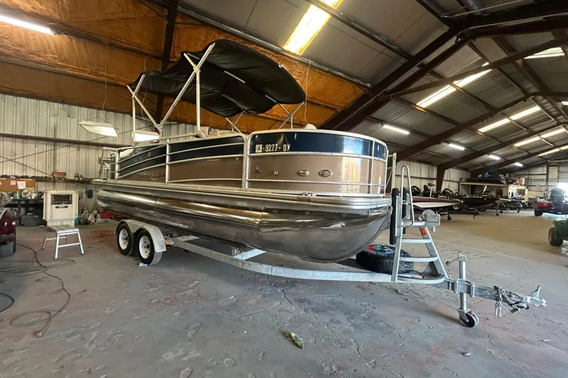 The Image of 2016 Berkshire STS Salt Edition pontoon boat in a spacious indoor storage facility. - 0
