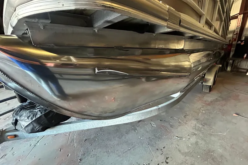 Slide: The Image of 2016 Berkshire STS Salt edition pontoon boat on trailer in a workshop. - 12