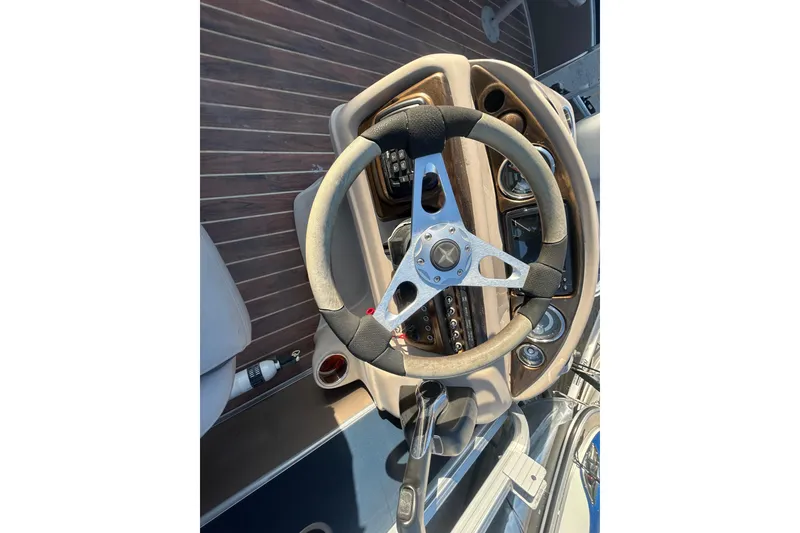 Slide: The Image of Steering wheel of 2016 Berkshire STS Salt edition boat with wooden dashboard. - 29
