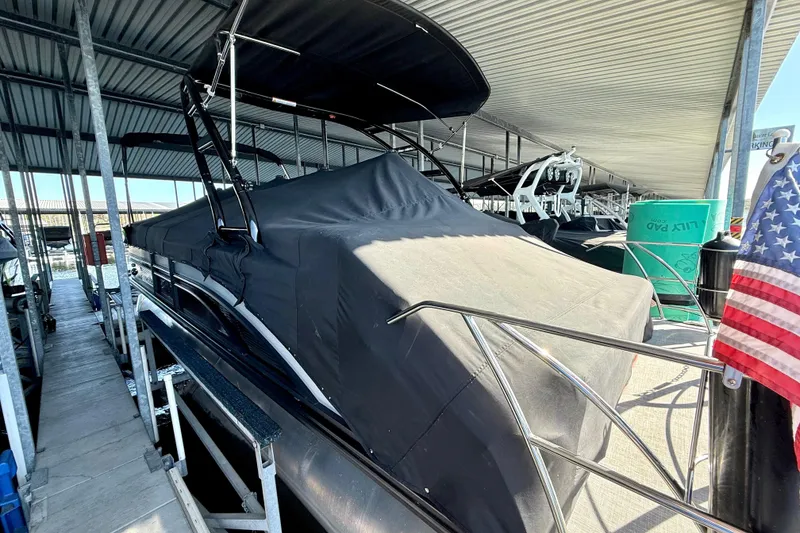 Slide: The Image of 2022 Harris Sunliner 250 pontoon boat covered in a marina dock. - 10