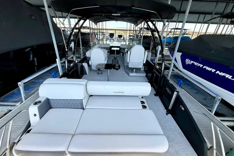 Slide: The Image of 2022 Harris Sunliner 250 pontoon boat interior with luxurious seating and modern design. - 12