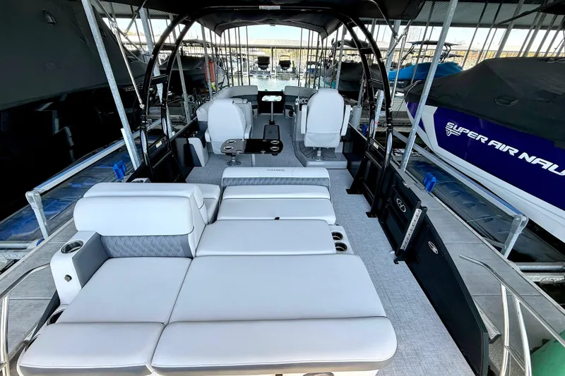 Slide: The Image of 2022 Harris Sunliner 250 pontoon boat interior with luxurious seating and modern design. - 14