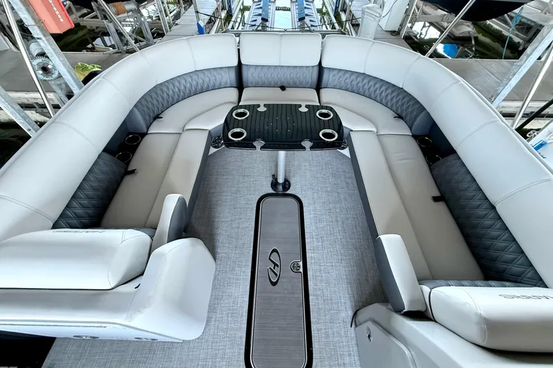 Slide: The Image of 2022 Harris Sunliner 250 boat interior with luxurious seating and central table. - 17