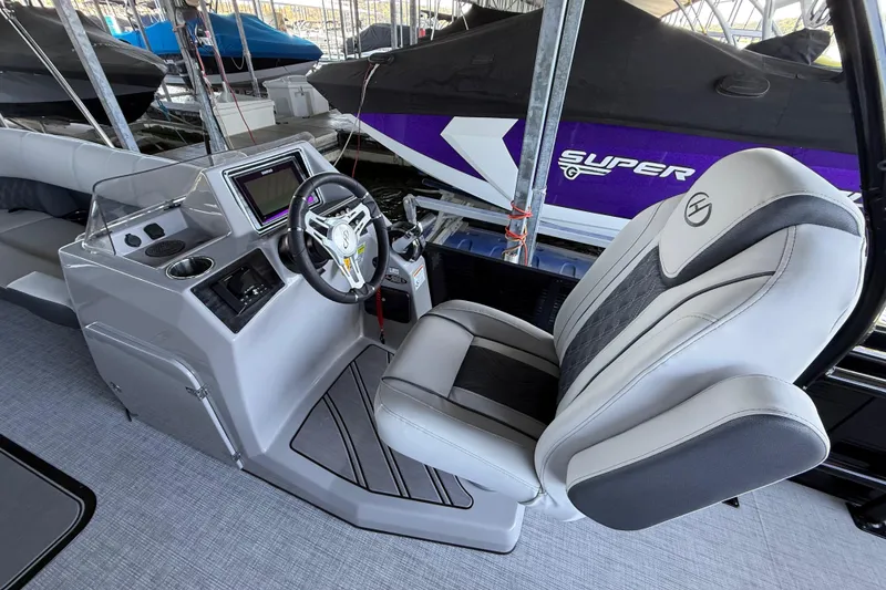 Slide: The Image of 2022 Harris Sunliner 250 boat interior with modern helm and comfortable captain's chair. - 19