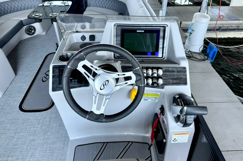 Slide: The Image of Cockpit of 2022 Harris Sunliner 250 boat with steering wheel and control panel. - 20