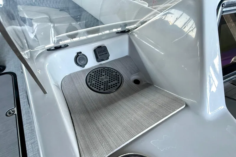 Slide: The Image of 2022 Harris Sunliner 250 boat dashboard with audio controls and charging port. - 25