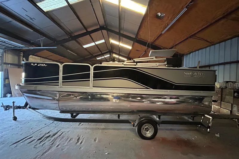 Slide: The Image of 2018 SunCatcher V20 Fish pontoon boat in a warehouse setting. - 11