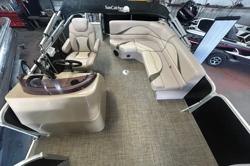 Slide: The Image of 2018 SunCatcher V20 Fish pontoon boat interior with beige seating and helm. - 15