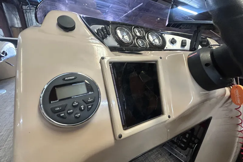 Slide: The Image of Control panel of a 2018 SunCatcher V20 Fish boat with gauges and radio. - 21