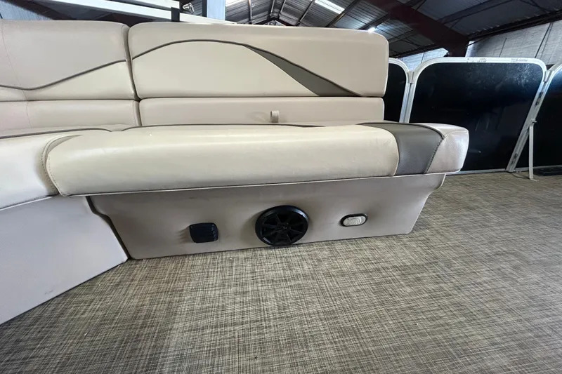 Slide: The Image of 2018 SunCatcher V20 Fish boat interior with beige seating and speaker system. - 22
