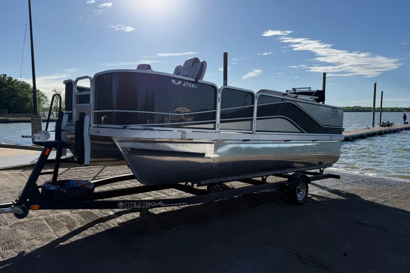 Slide: The Image of 2018 SunCatcher V20 Fish pontoon boat on trailer by a lake dock. - 25