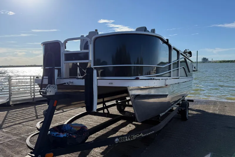 Slide: The Image of 2018 SunCatcher V20 Fish boat on trailer by a sunny lakeside. - 27