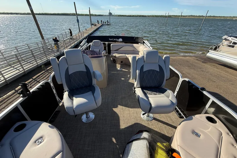 Slide: The Image of 2018 SunCatcher V20 Fish pontoon boat docked by a serene lake. - 28